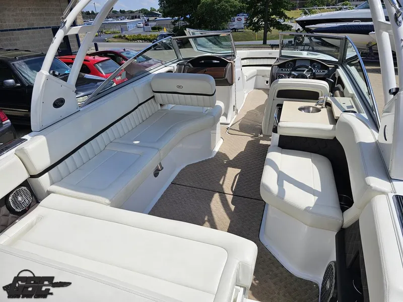 Slide: The Image of 2015 Cobalt A28 boat interior with white seating and modern dashboard. - 35