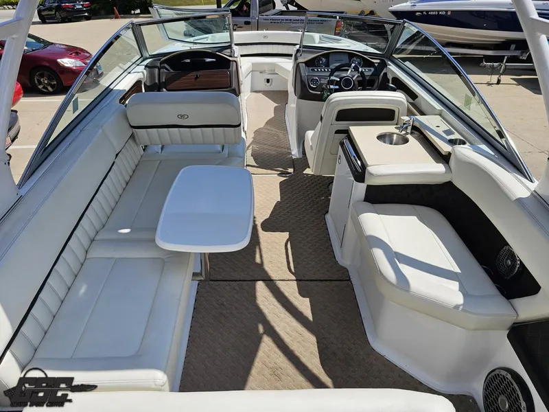 Slide: The Image of 2015 Cobalt A28 boat interior with white seating and table, showcasing luxury design. - 38