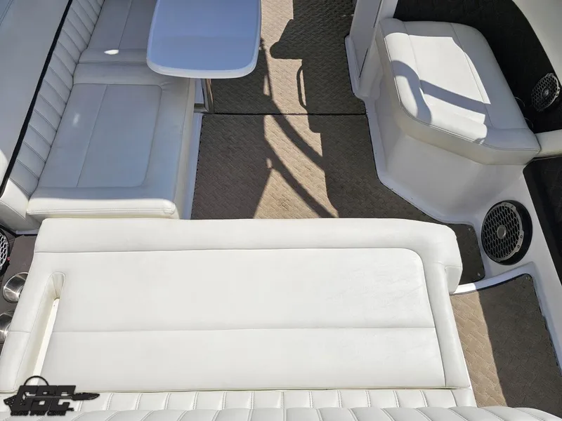 Slide: The Image of Interior of a 2015 Cobalt A28 boat with white seating and table. - 39