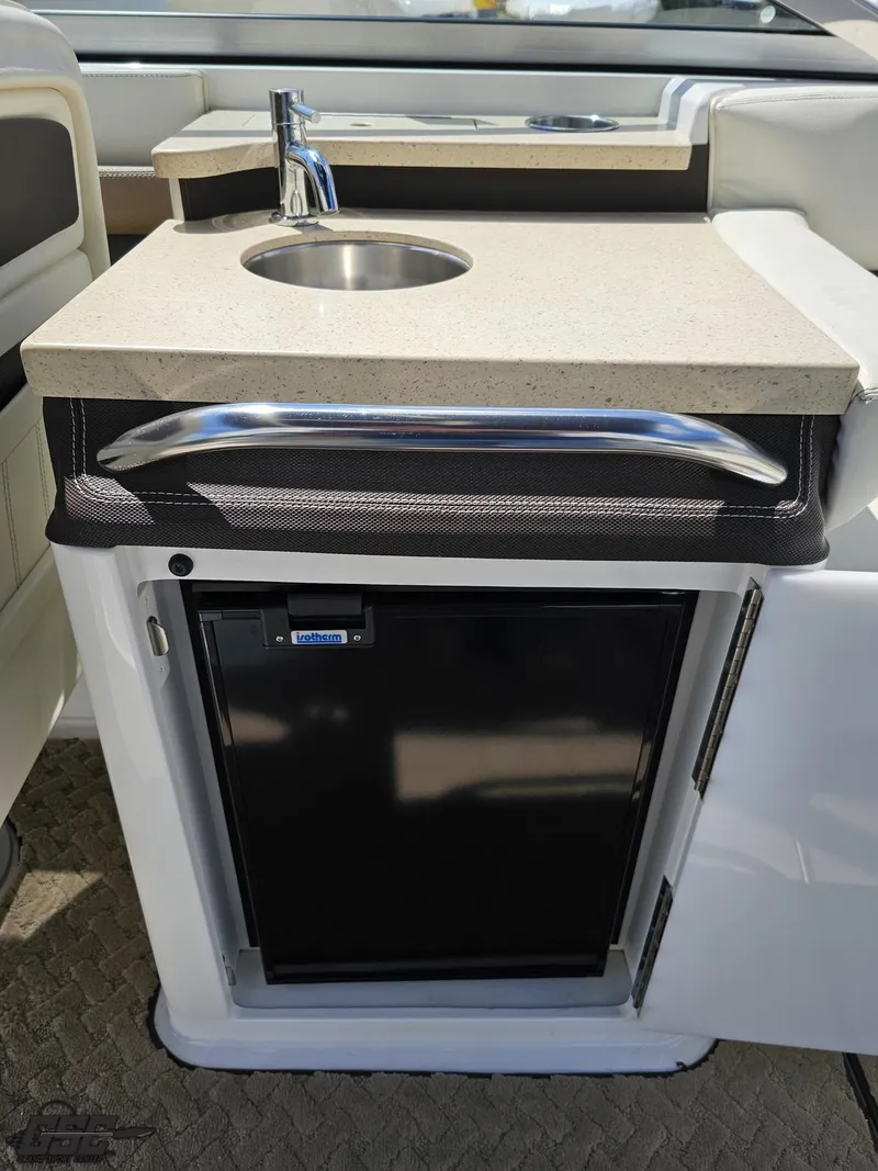 Slide: The Image of 2015 Cobalt A28 boat kitchenette with sink and mini fridge. - 44
