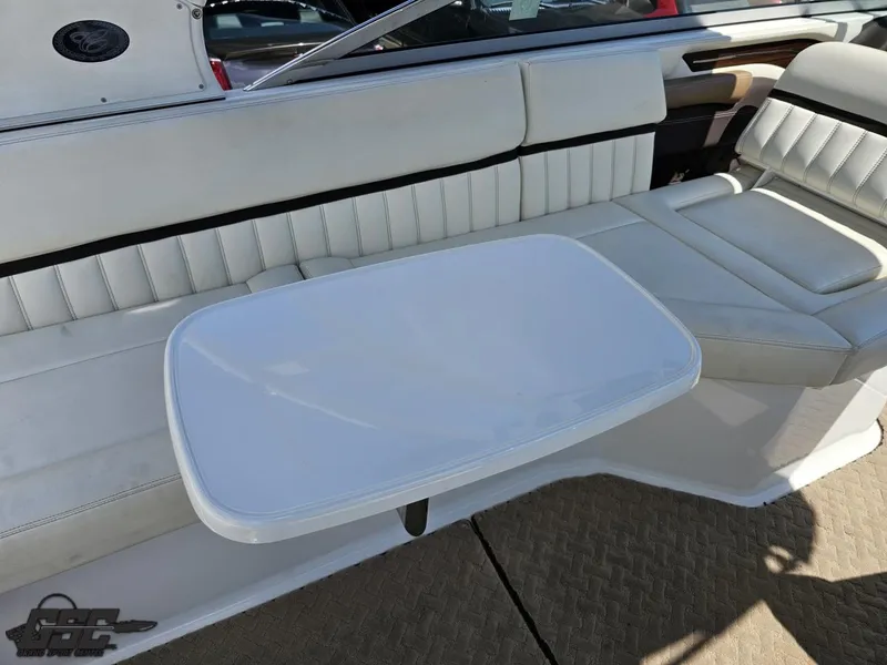 Slide: The Image of 2015 Cobalt A28 boat interior with white seating and table. - 45