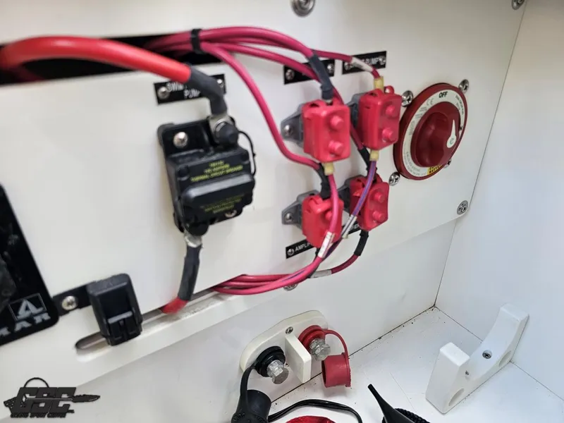 Slide: The Image of Electrical panel with red wires and switches in a 2015 Cobalt A28 boat. - 48