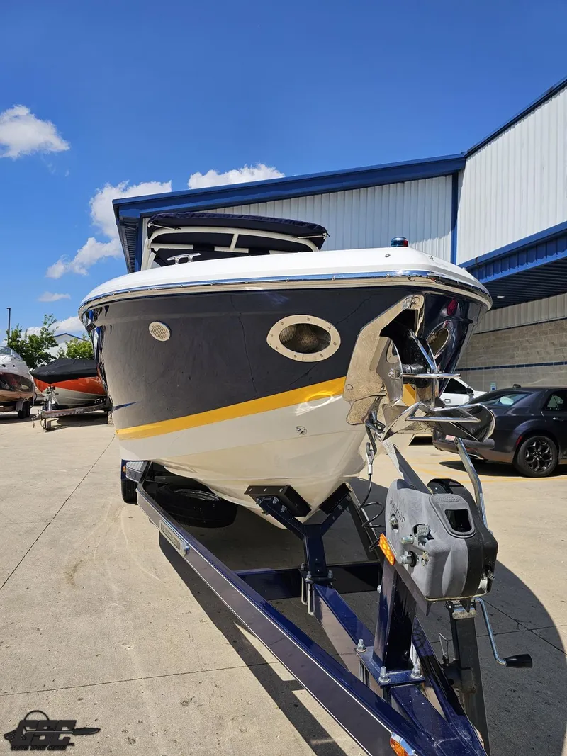 Slide: The Image of 2015 Cobalt A28 boat on trailer, parked outdoors under a clear blue sky. - 8