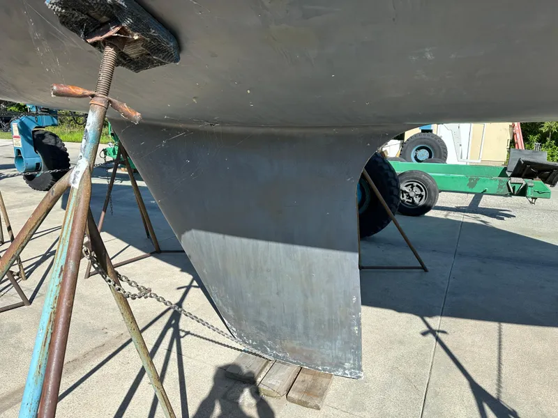 Slide: The Image of Keel of a 1989 C&C 30 sailboat on stands, in a boatyard. - 10