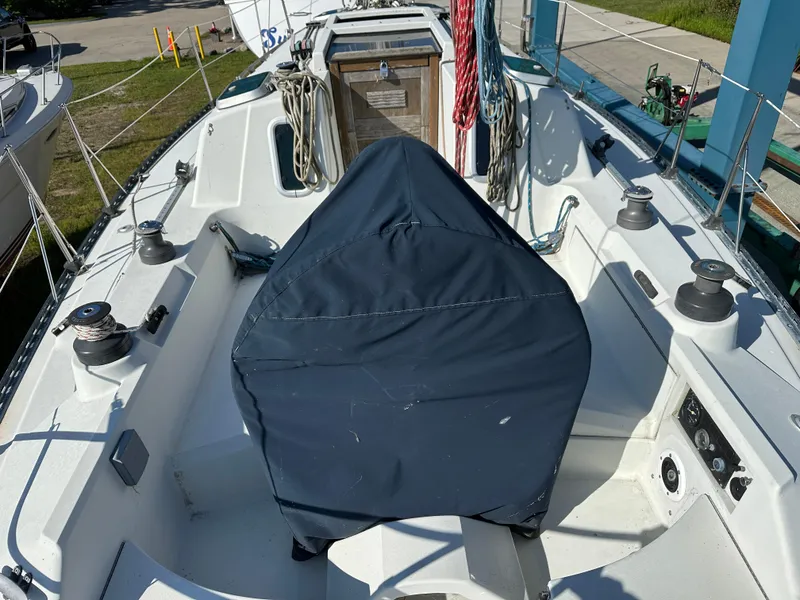 Slide: The Image of Cockpit of a 1989 C&C 30 sailboat with covered steering wheel and winches. - 11