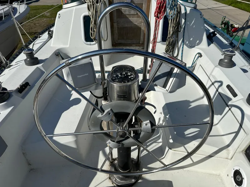 Slide: The Image of Cockpit of 1989 C&C 30 sailboat with steering wheel and navigation instruments. - 12