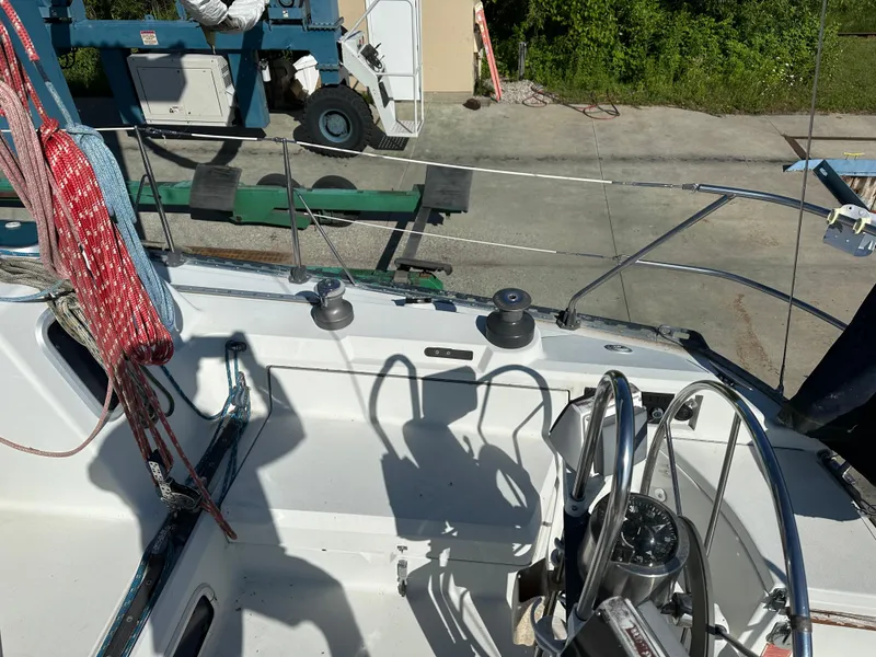 Slide: The Image of Cockpit of a 1989 C&C 30 sailboat with ropes and steering wheel. - 15