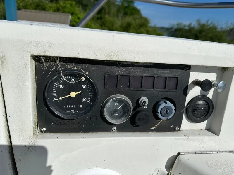 Slide: The Image of Control panel of a 1989 C&C 30 boat with RPM gauge and switches. - 17