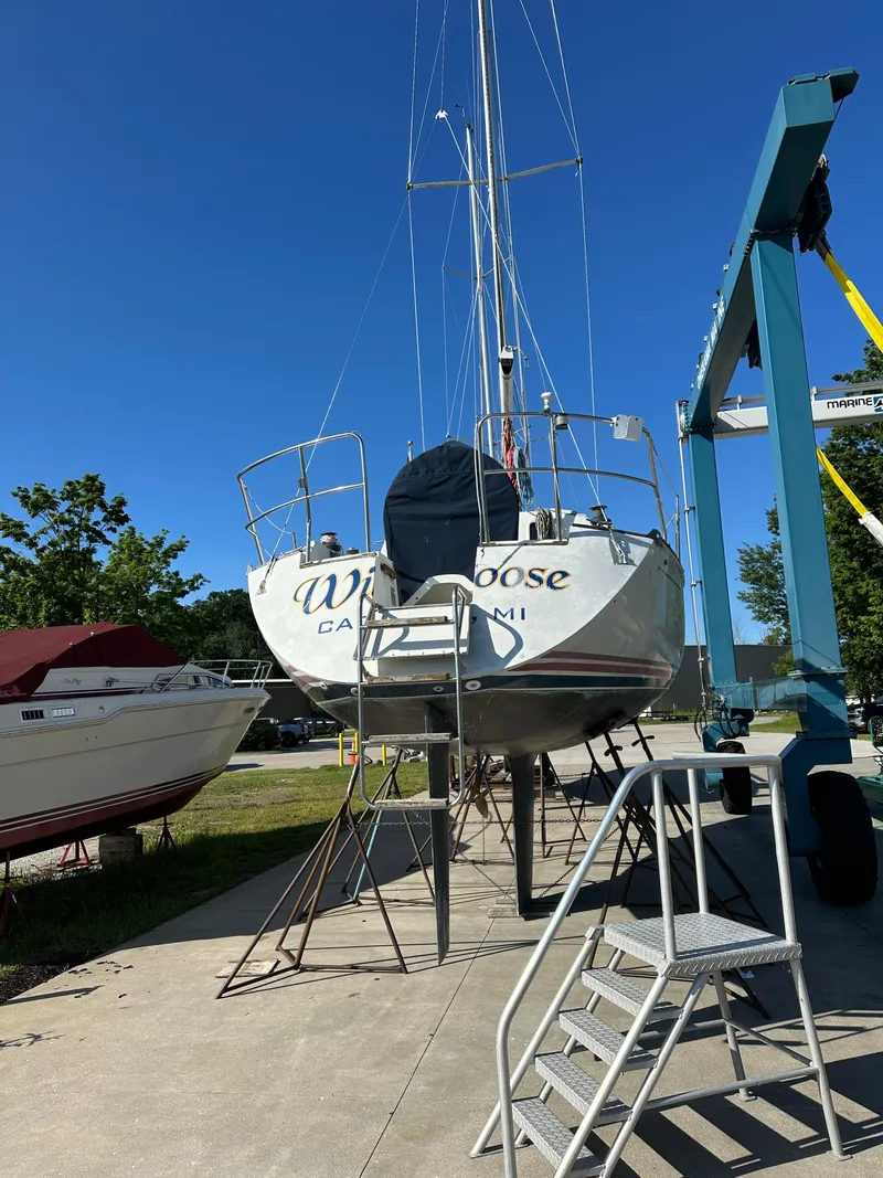 Slide: The Image of Sailboat on dry dock, C&C 30 model, 1989, with clear blue sky background. - 2