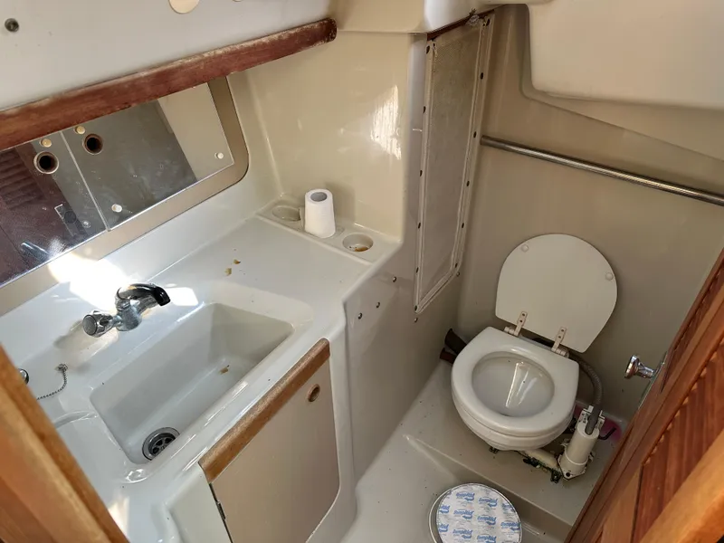 Slide: The Image of Compact bathroom in a 1989 C&C 30 sailboat with sink and toilet. - 27