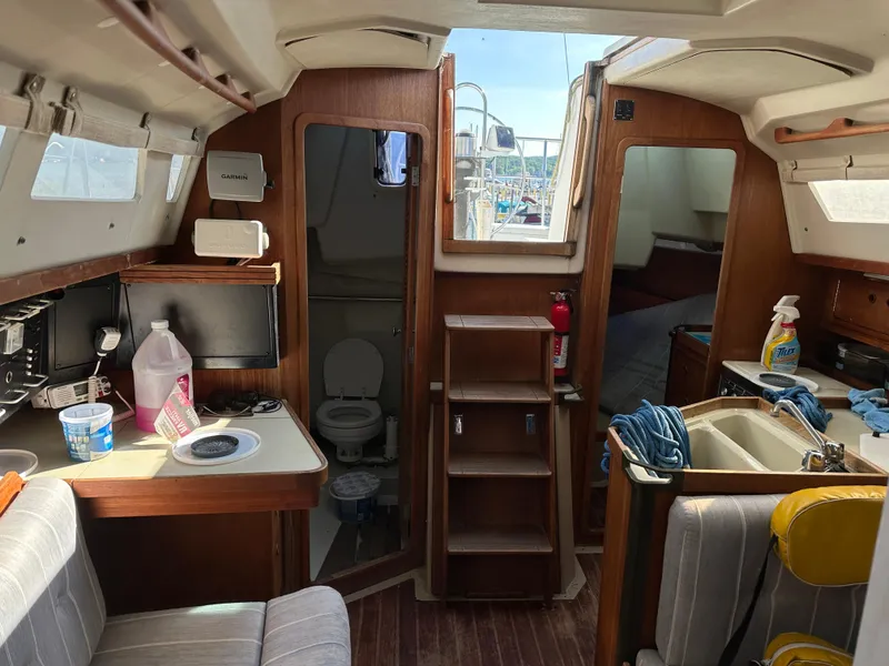 Slide: The Image of Interior of 1989 C&C 30 sailboat with kitchenette, seating, and bathroom. - 29
