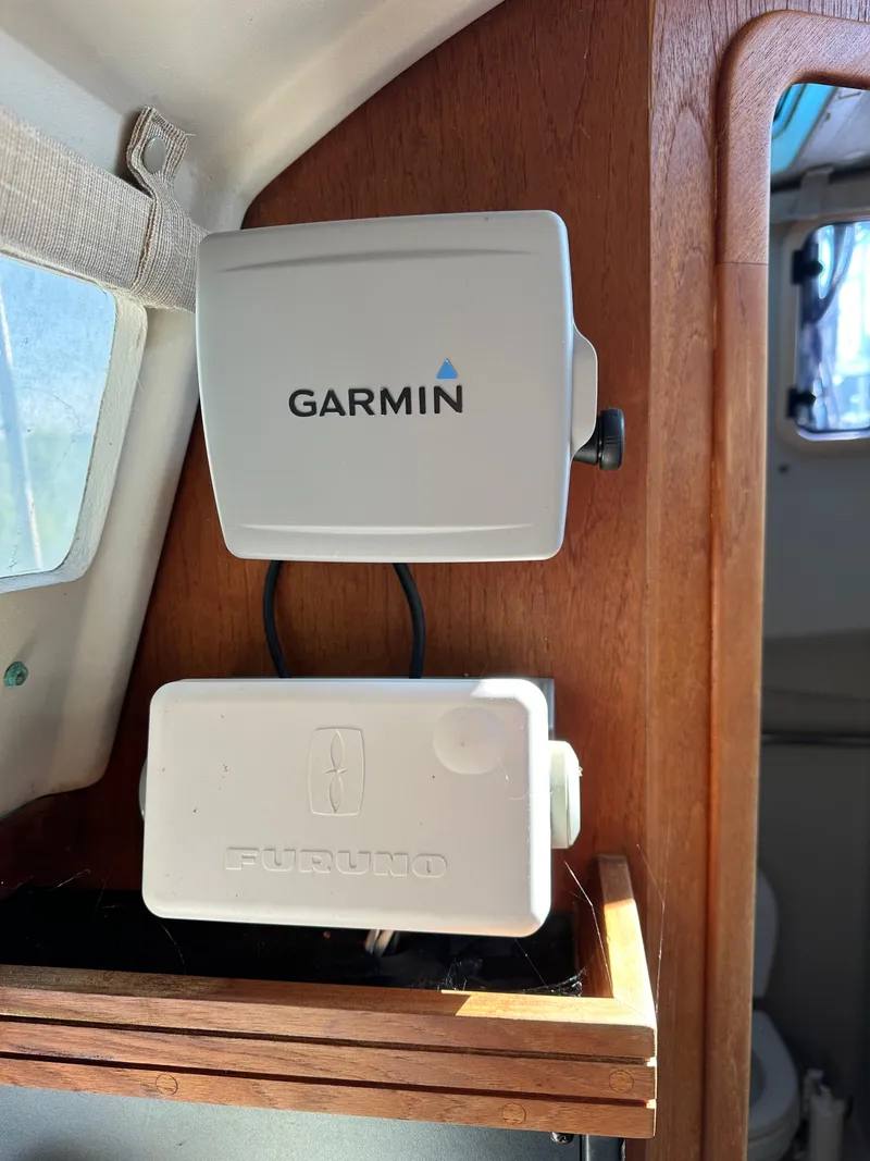 Slide: The Image of Garmin and Furuno devices installed on a 1989 C&C 30 sailboat interior. - 30