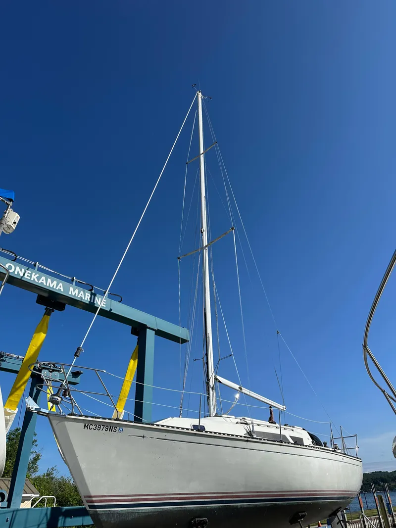 Slide: The Image of 1989 C&C 30 sailboat at Onekama Marine, under clear blue sky. - 5