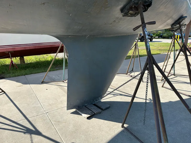 Slide: The Image of Keel of a 1989 C&C 30 sailboat on stands, outdoor setting. - 6