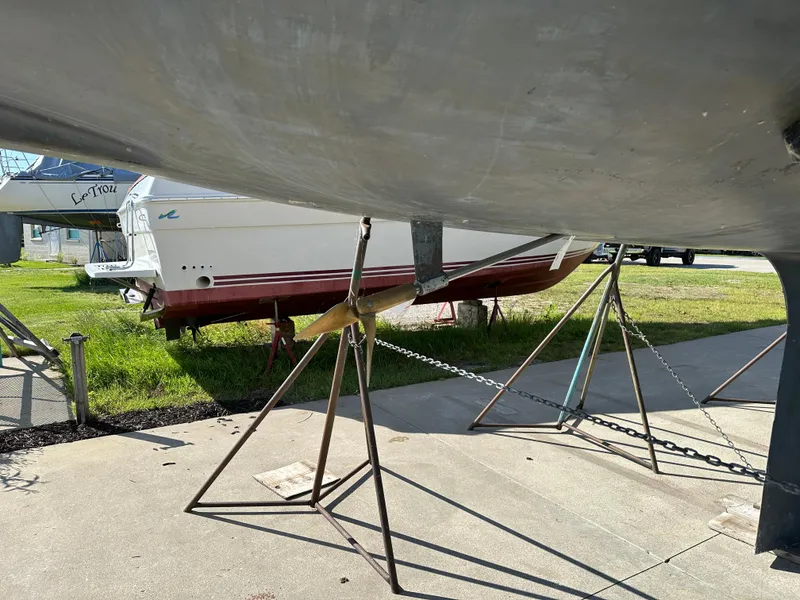 Slide: The Image of Sailboat hull on stands, C&C 30 model, 1989, in a boatyard setting. - 7