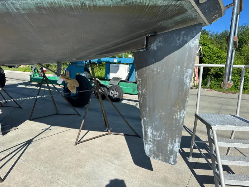 Slide: The Image of 1989 C&C 30 sailboat keel and propeller on dry dock, with maintenance equipment nearby. - 9