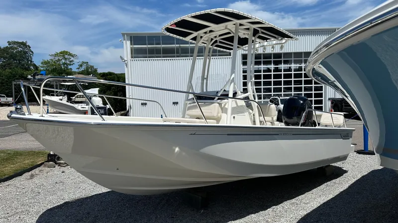 The Image of 2025 Boston Whaler 190 Montauk boat displayed outdoors near a modern building. - 0