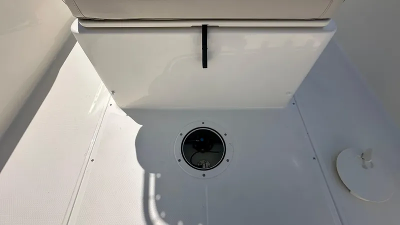 Slide: The Image of Interior view of 2025 Boston Whaler 190 Montauk boat, featuring storage compartment and deck details. - 11