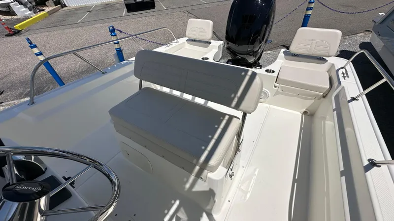 Slide: The Image of 2025 Boston Whaler 190 Montauk boat interior with seating and steering wheel. - 12