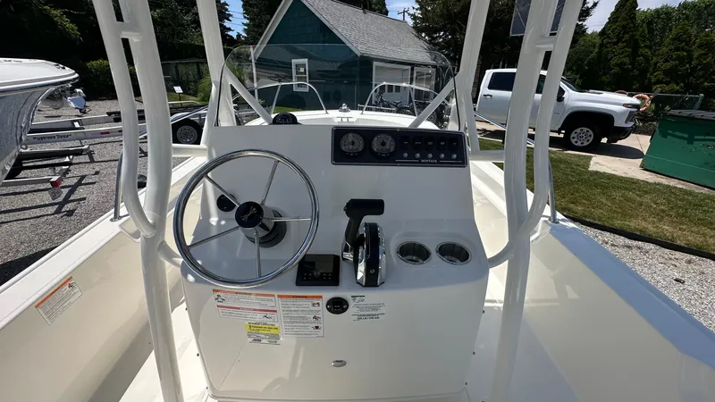 Slide: The Image of 2025 Boston Whaler 190 Montauk boat console with steering wheel and controls. - 13