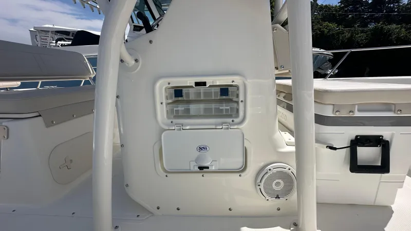 Slide: The Image of 2025 Boston Whaler 190 Montauk interior, featuring storage compartment and speaker. - 20