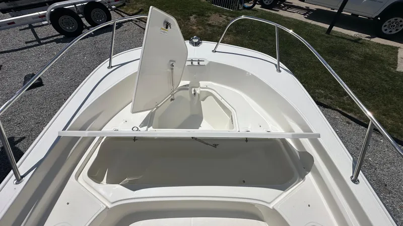 Slide: The Image of 2025 Boston Whaler 190 Montauk boat with open storage compartment, viewed from above. - 25