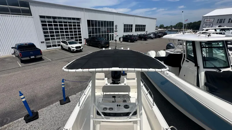 Slide: The Image of 2025 Boston Whaler 190 Montauk boat at a dealership with cars and other boats. - 29