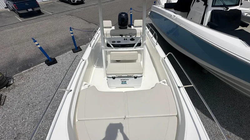 Slide: The Image of 2025 Boston Whaler 190 Montauk boat, white interior, parked in a marina. - 30