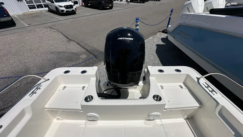 Slide: The Image of 2025 Boston Whaler 190 Montauk boat with Mercury engine in a parking lot. - 5