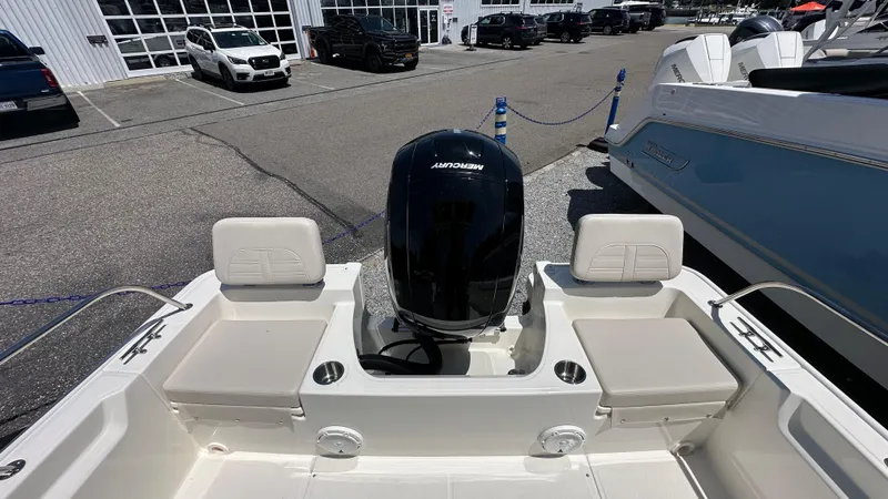 Slide: The Image of 2025 Boston Whaler 190 Montauk boat with Mercury engine, parked at a dealership. - 7