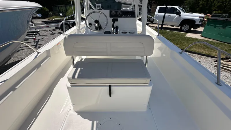 Slide: The Image of 2025 Boston Whaler 190 Montauk boat interior with steering console and seating. - 8