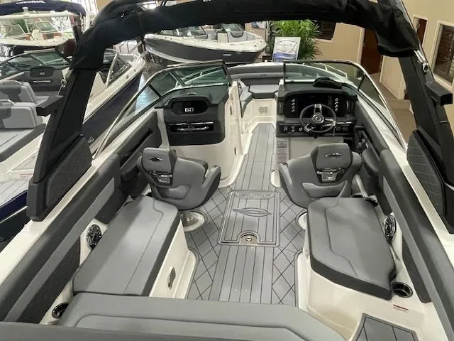 Slide: The Image of 2025 Chaparral 26 Surf boat interior with modern seating and dashboard design. - 11