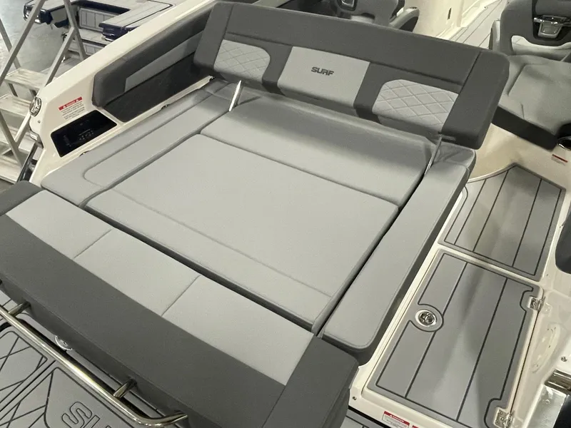 Slide: The Image of 2025 Chaparral 26 Surf boat interior with gray cushioned seating and sleek design. - 15