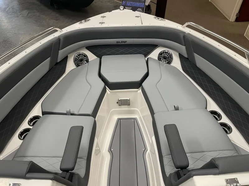 Slide: The Image of 2025 Chaparral 26 Surf boat interior with gray seating and cup holders. - 4