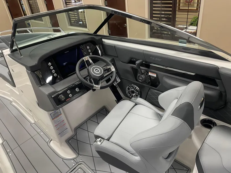 Slide: The Image of 2025 Chaparral 26 Surf boat interior with modern dashboard and steering wheel. - 6