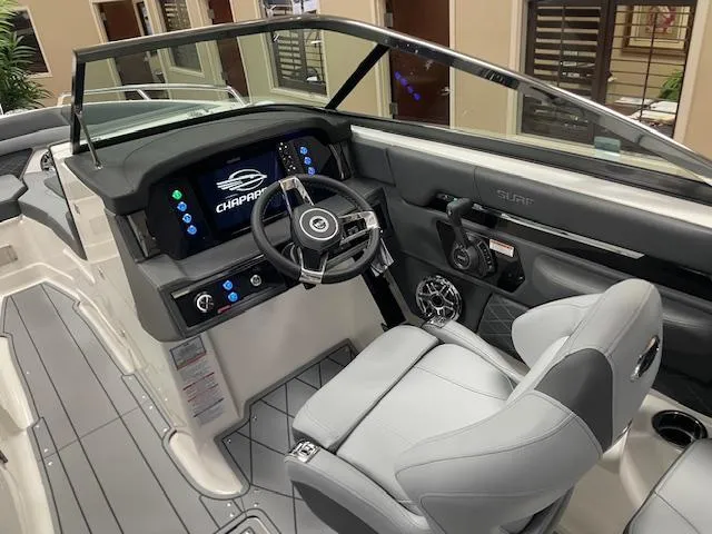 Slide: The Image of 2025 Chaparral 26 Surf boat interior with modern dashboard and steering wheel. - 9