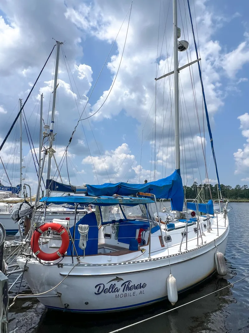 The Image of Sailboat Tayana Vancouver 42, 1986 model, docked with blue covers and clear sky. - 1