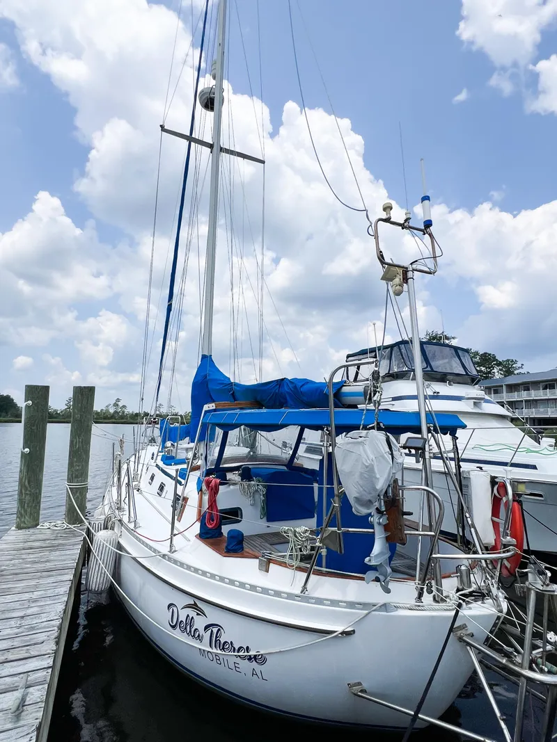 Slide: The Image of 1986 Tayana Vancouver 42 sailboat docked under a cloudy sky. - 11