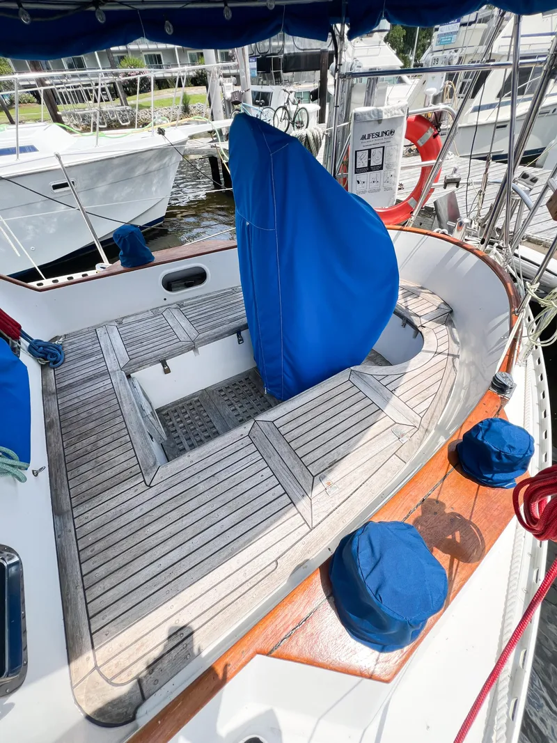 Slide: The Image of 1986 Tayana Vancouver 42 sailboat cockpit with blue covers and wooden deck. - 13
