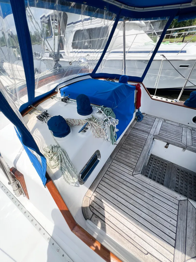 Slide: The Image of Cockpit of 1986 Tayana Vancouver 42 sailboat with blue canvas and wooden deck. - 14