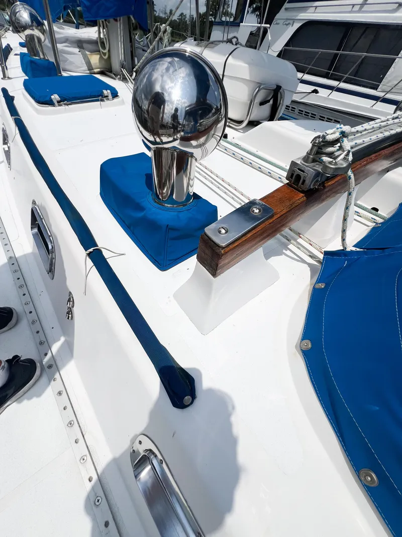 Slide: The Image of 1986 Tayana Vancouver 42 yacht deck with blue covers and polished metal fittings. - 15