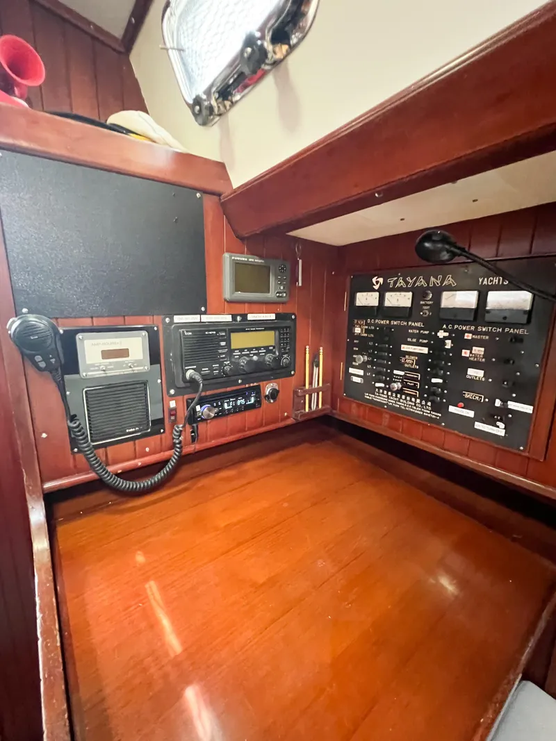 Slide: The Image of Navigation station of 1986 Tayana Vancouver 42 yacht with control panels and communication equipment. - 19