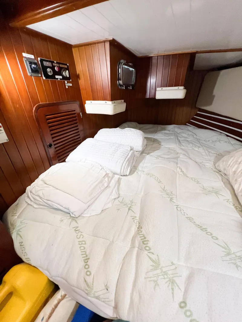 Slide: The Image of Cozy cabin interior of 1986 Tayana Vancouver 42 sailboat with wooden paneling and bedding. - 21