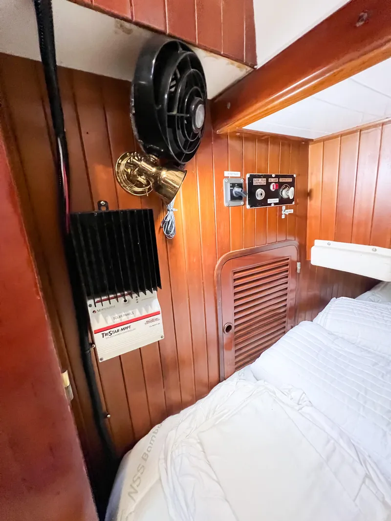 Slide: The Image of Interior of 1986 Tayana Vancouver 42 yacht cabin with fan, light, and control panel. - 22