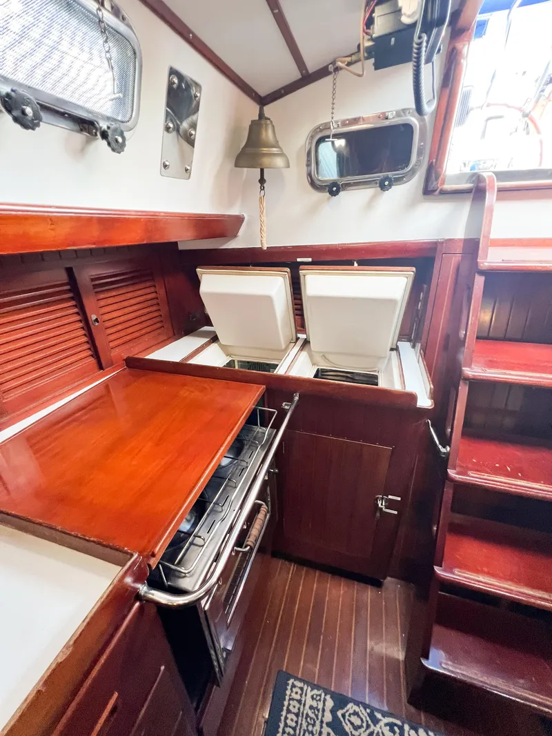Slide: The Image of Interior of 1986 Tayana Vancouver 42 sailboat galley with wood finish and appliances. - 24