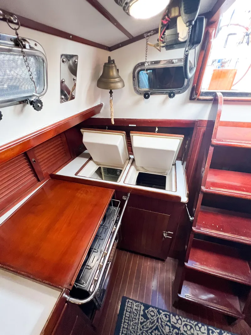 Slide: The Image of Interior of 1986 Tayana Vancouver 42 sailboat with wooden cabinetry and steps. - 25
