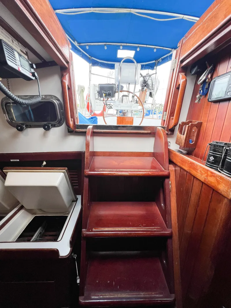Slide: The Image of Interior view of 1986 Tayana Vancouver 42 sailboat with wooden stairs and blue canopy. - 28