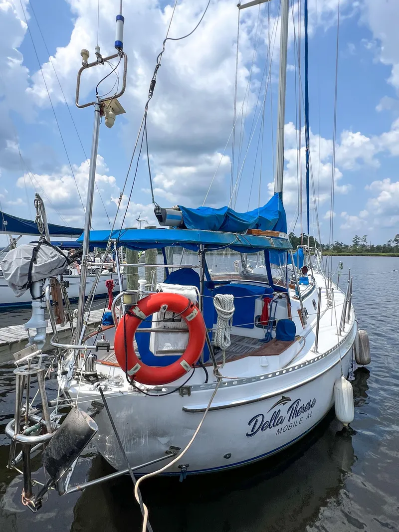 Slide: The Image of 1986 Tayana Vancouver 42 sailboat docked with blue canopy and lifebuoy. - 3