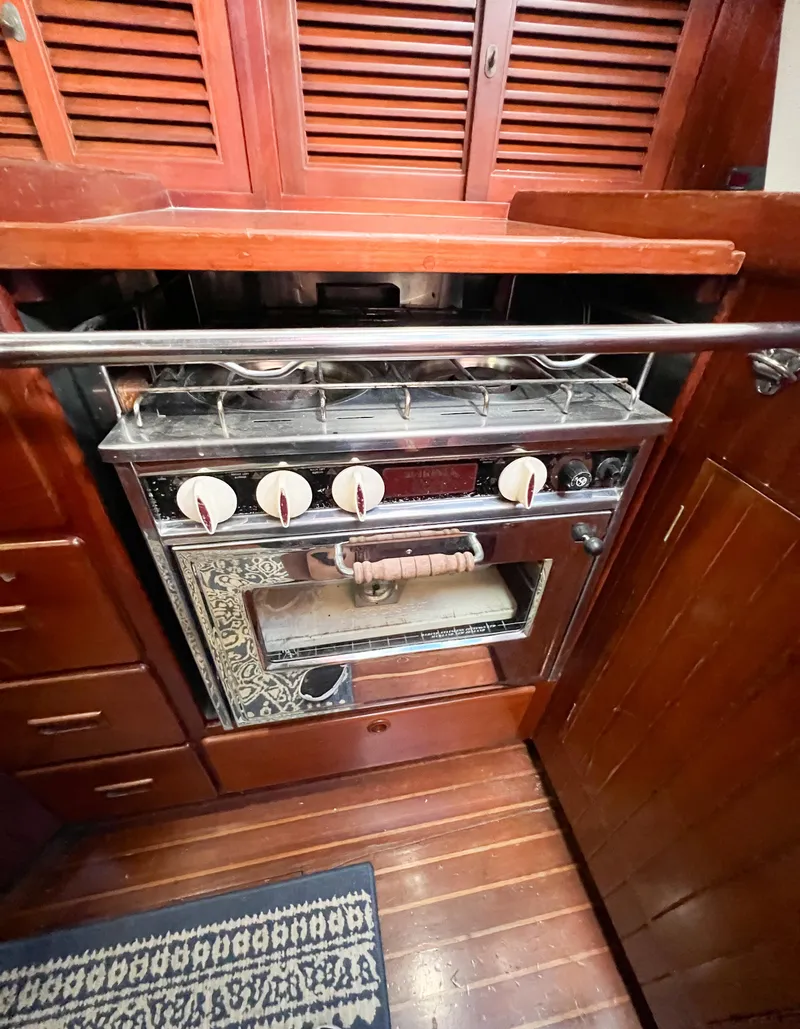 Slide: The Image of Vintage stove in 1986 Tayana Vancouver 42 yacht kitchen with wooden cabinetry. - 31