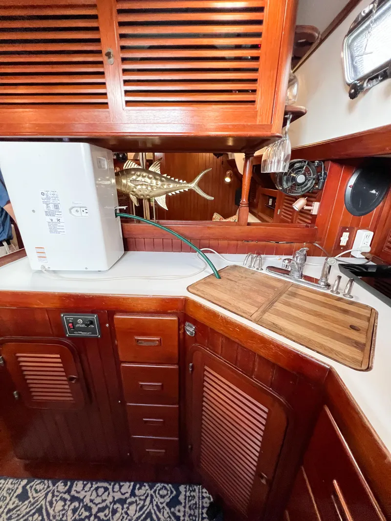 Slide: The Image of 1986 Tayana Vancouver 42 yacht kitchen with wooden cabinetry and countertop. - 32